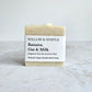 simple cream beige square soap bar with specks. white paper label with black text, simplistic minimalist label