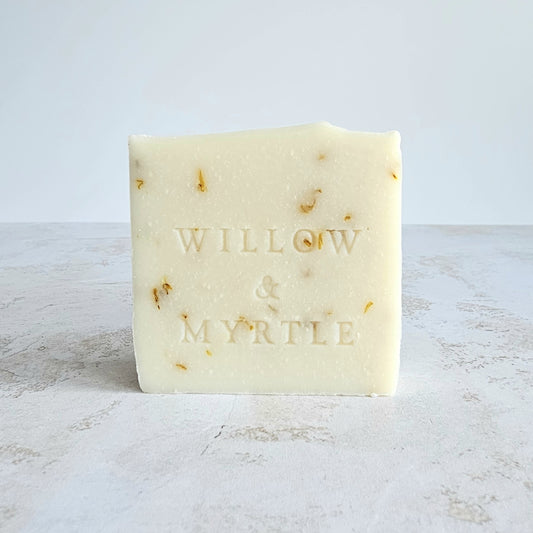 beige creamy soap with yellow specs of calendula petal