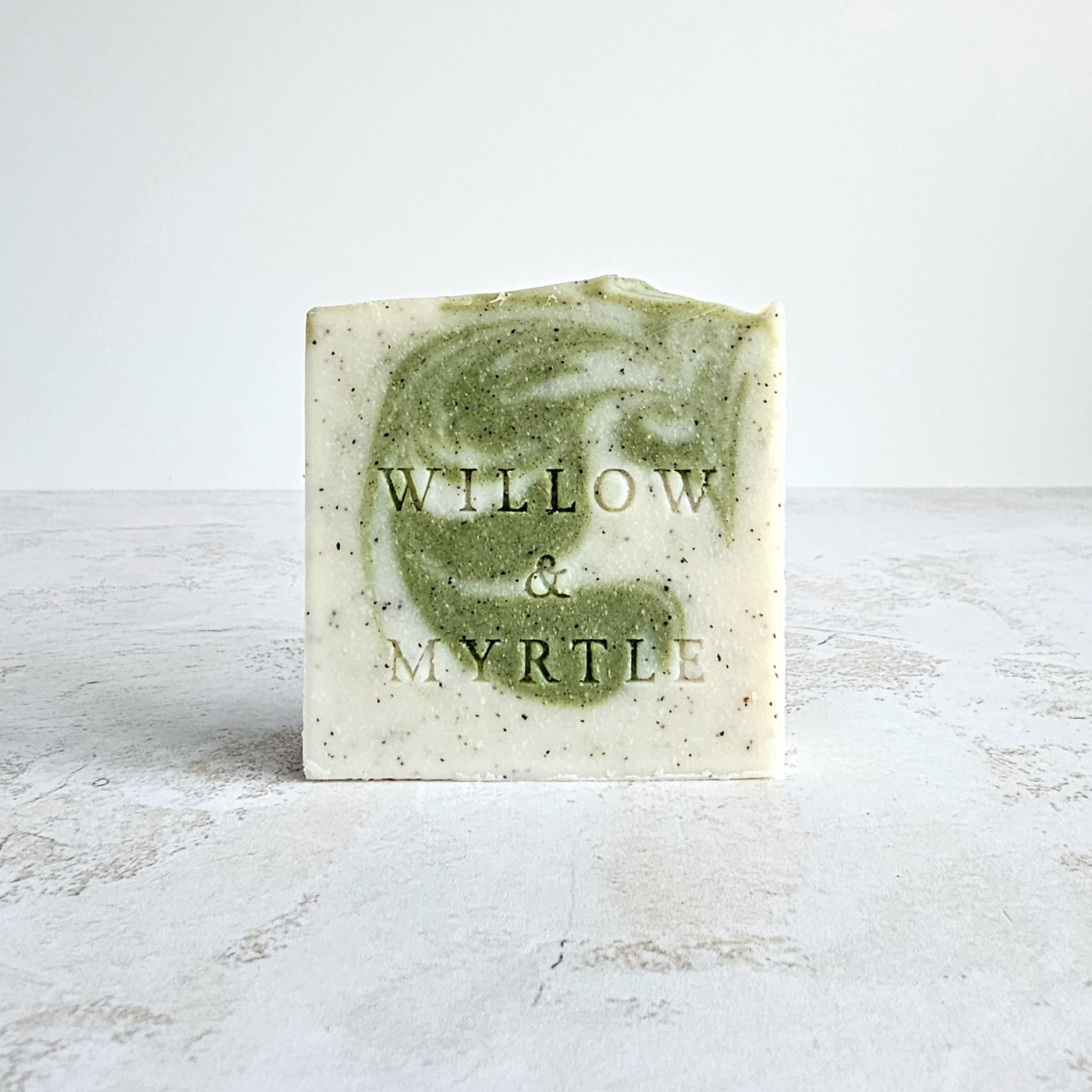 lime patchouli soap, green swirl, ground apricot stone specs.