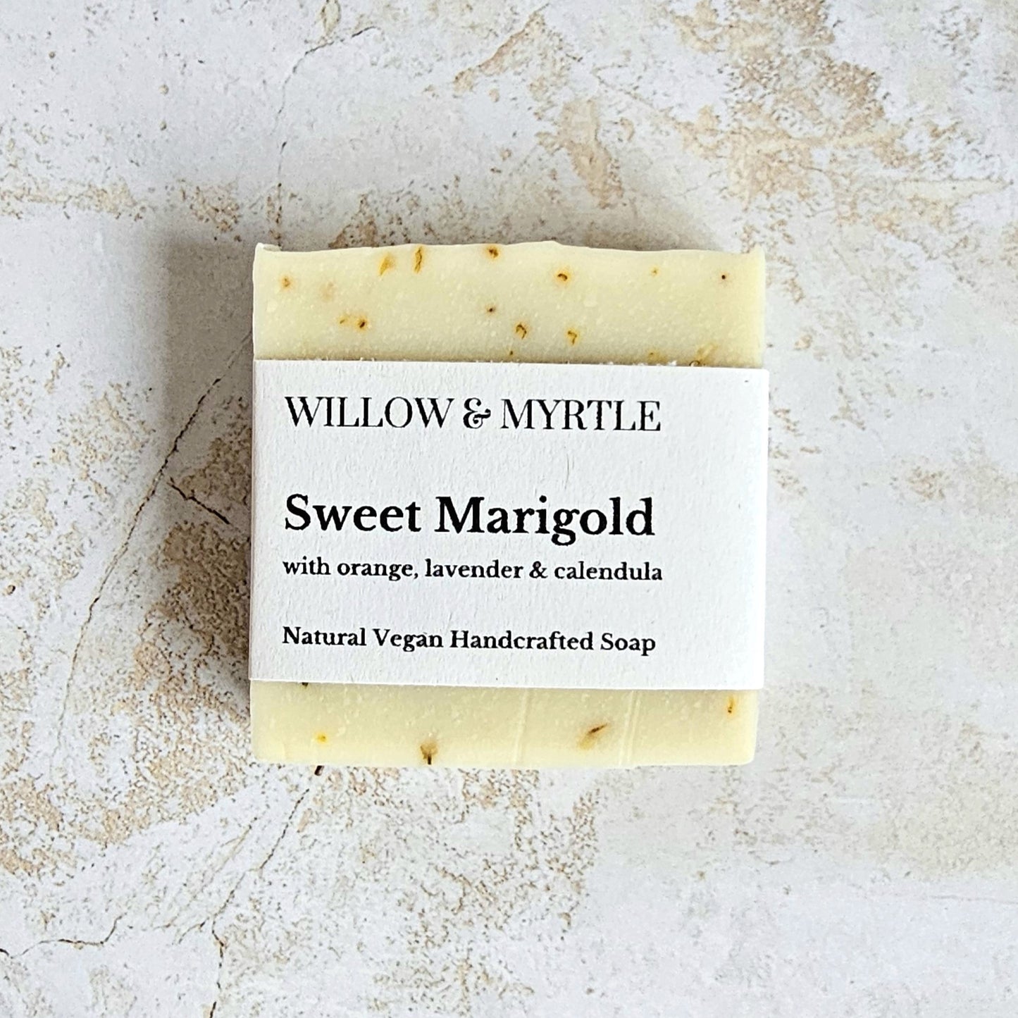 pale yellow soap bar with specs of calendula petals