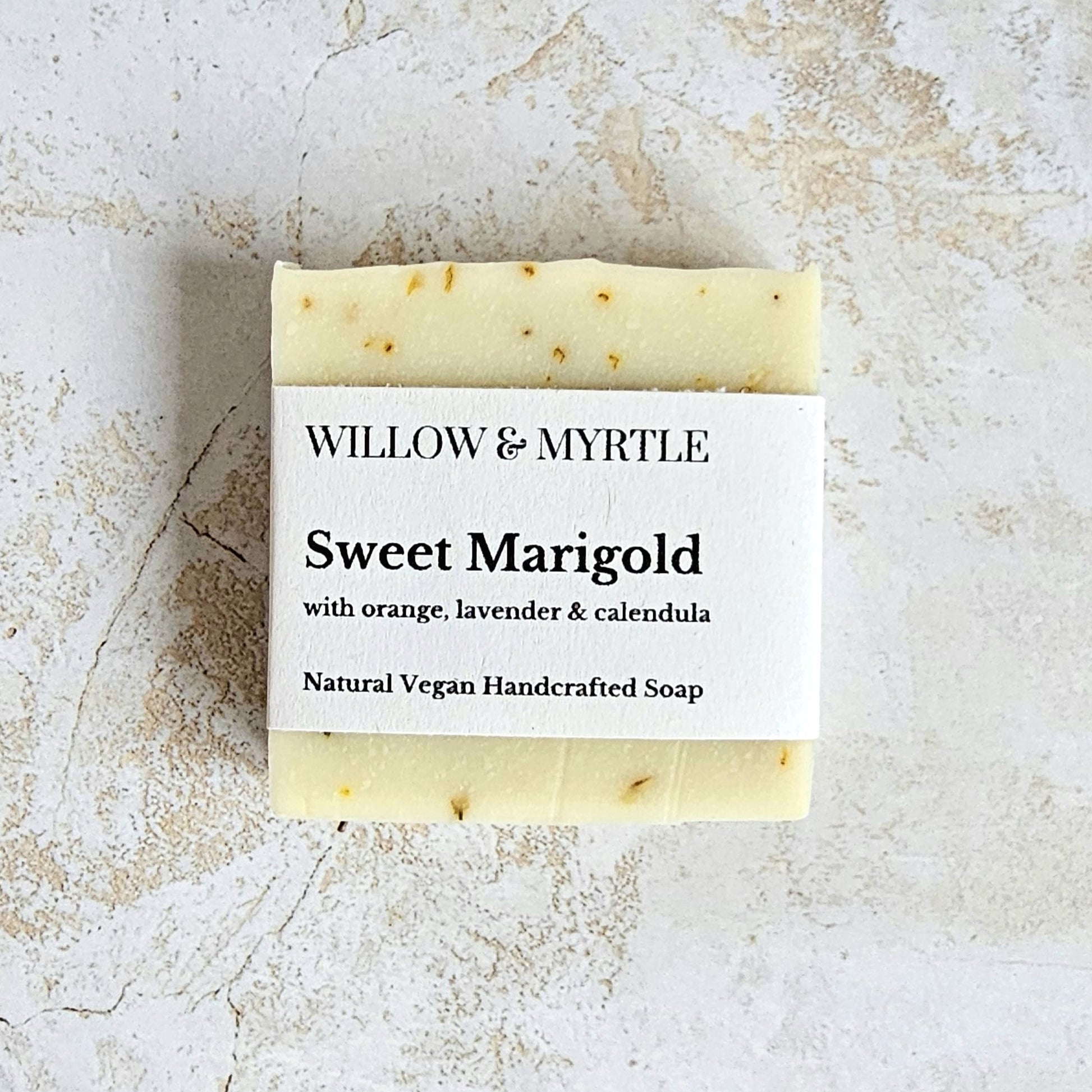 pale yellow soap bar with specs of calendula petals