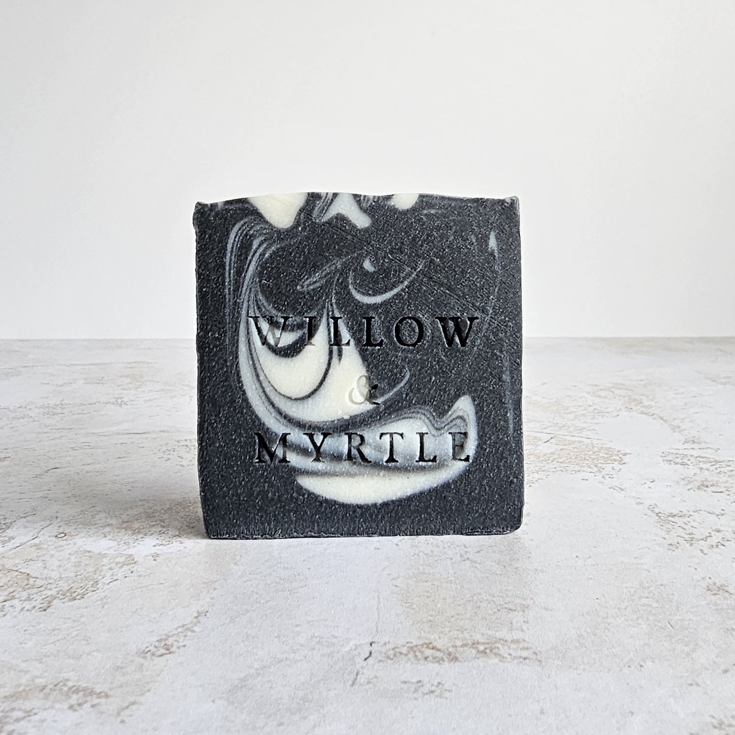 black soap with cream swirl, charcoal soap