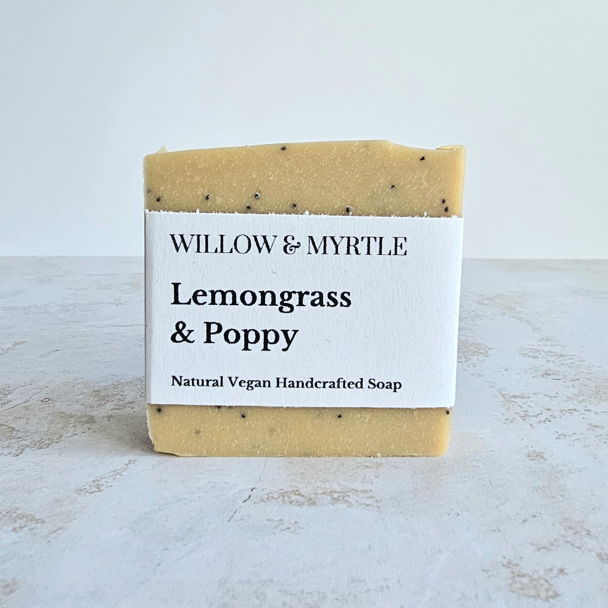 pale yellow coloured soap with black poppy seeds