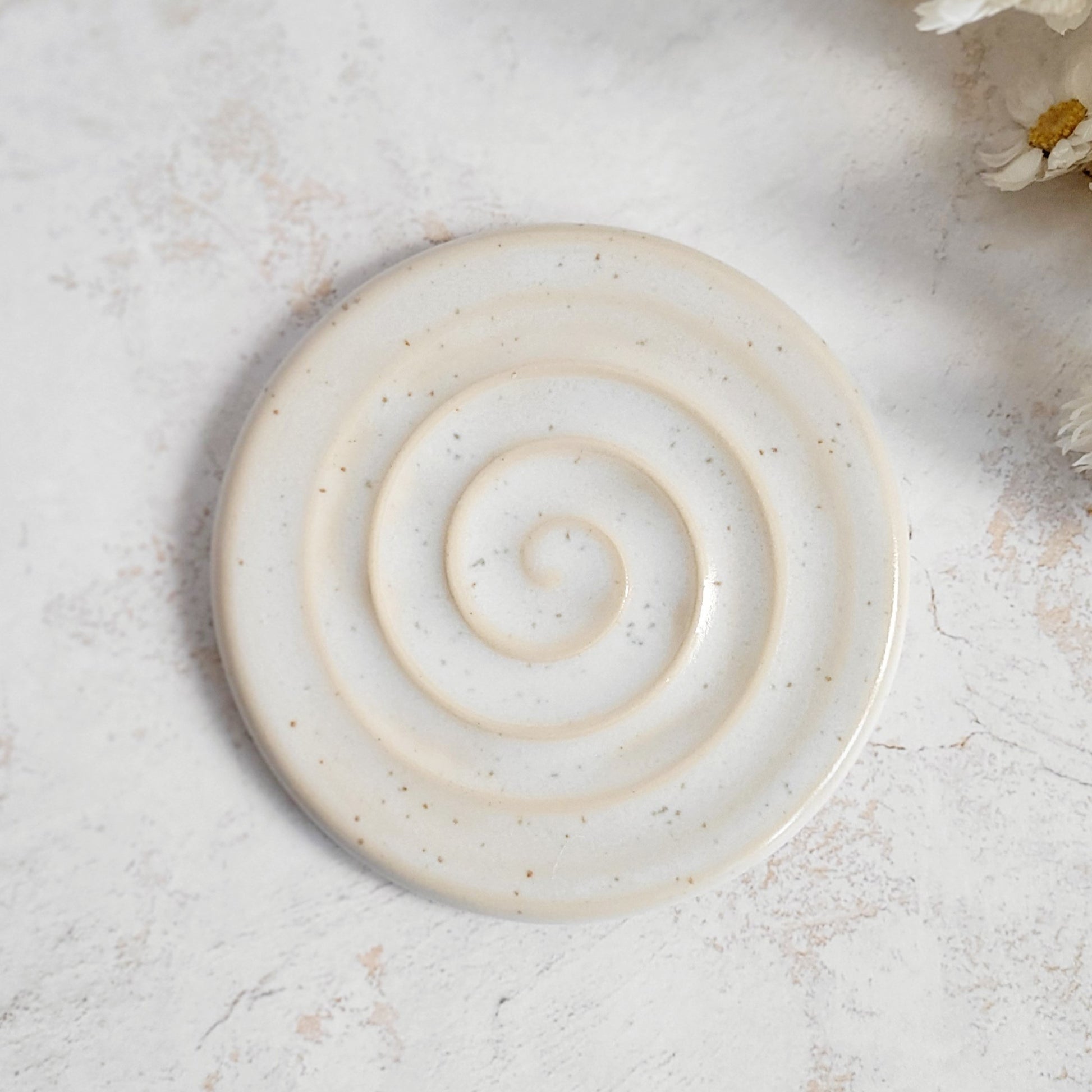 white round ceramic soap dish. perfect for drainage. 